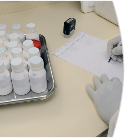 scientist writing on notepad